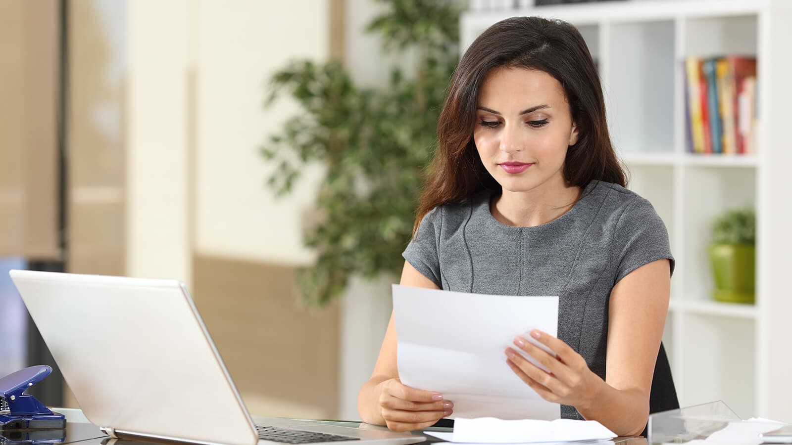 woman reading a paper