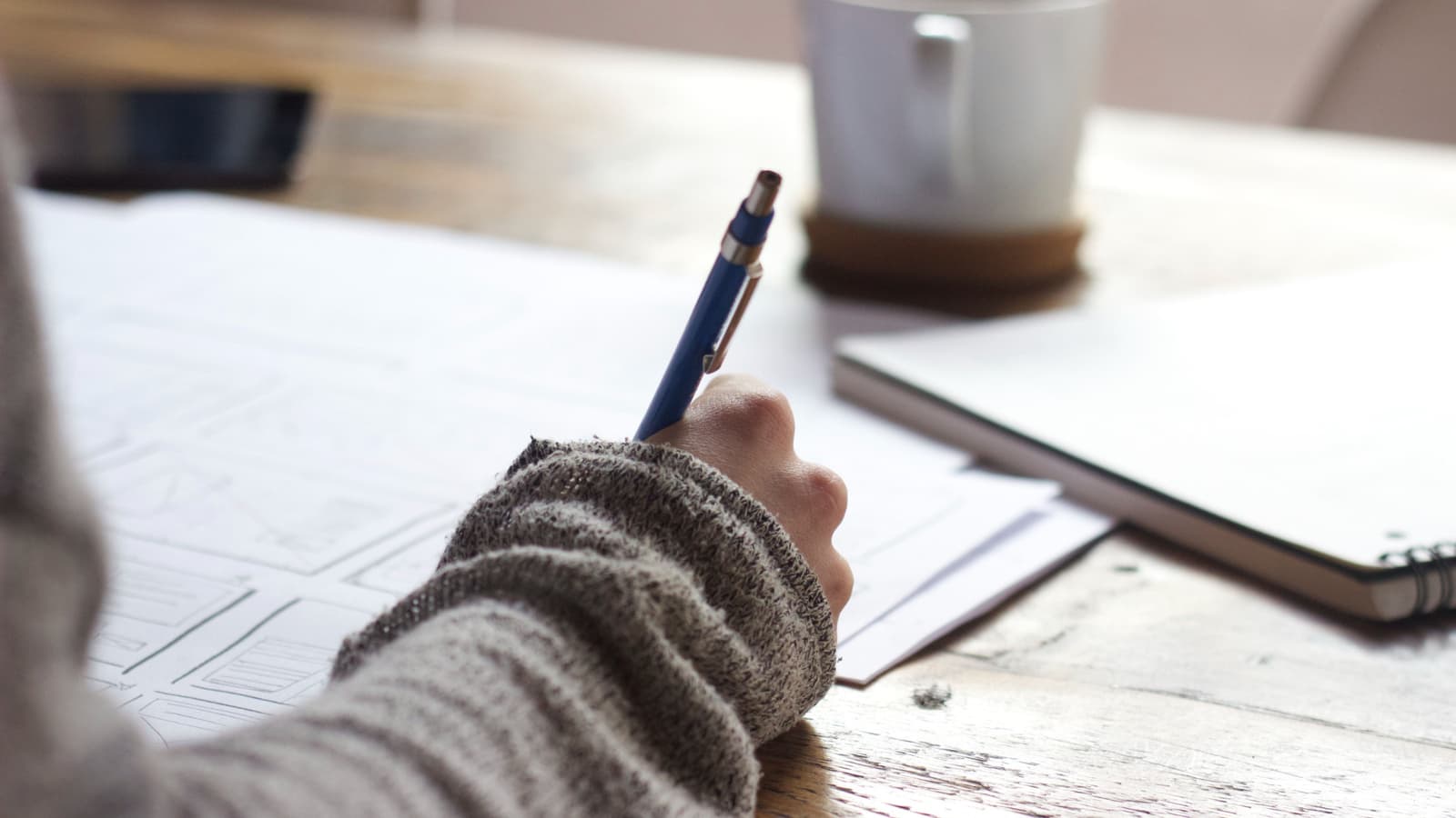 Hand holding pen and writing 