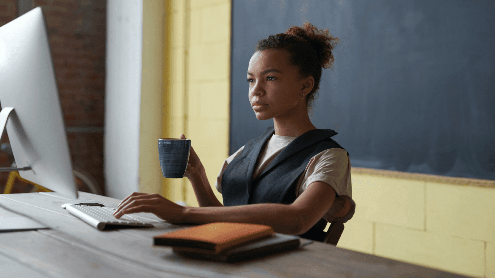 woman on computer, looking at camera