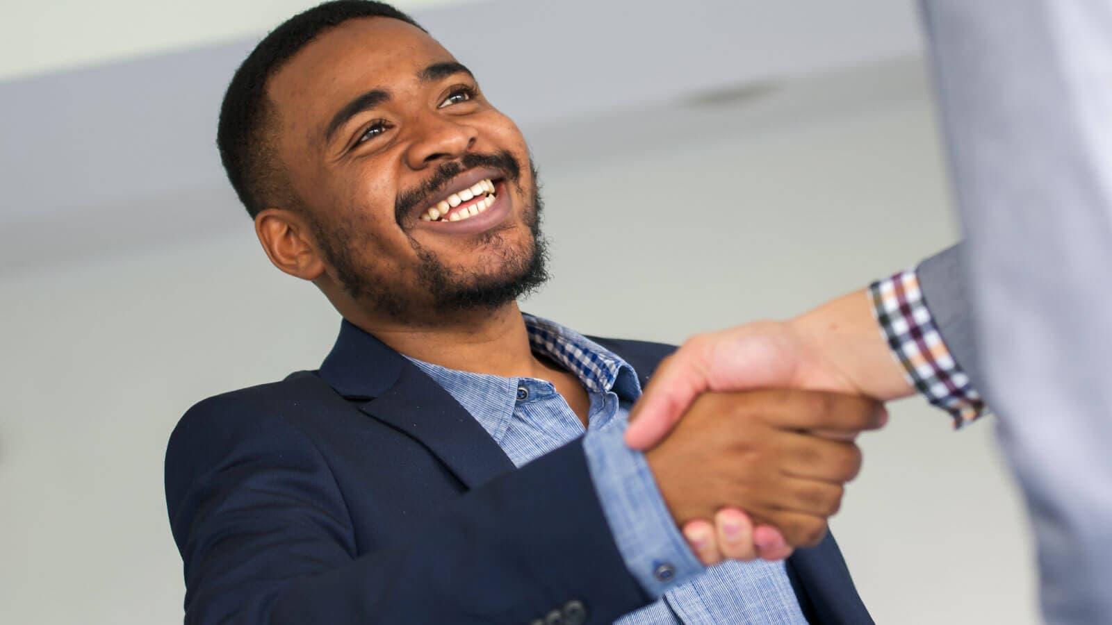 Man smiling and shaking hands