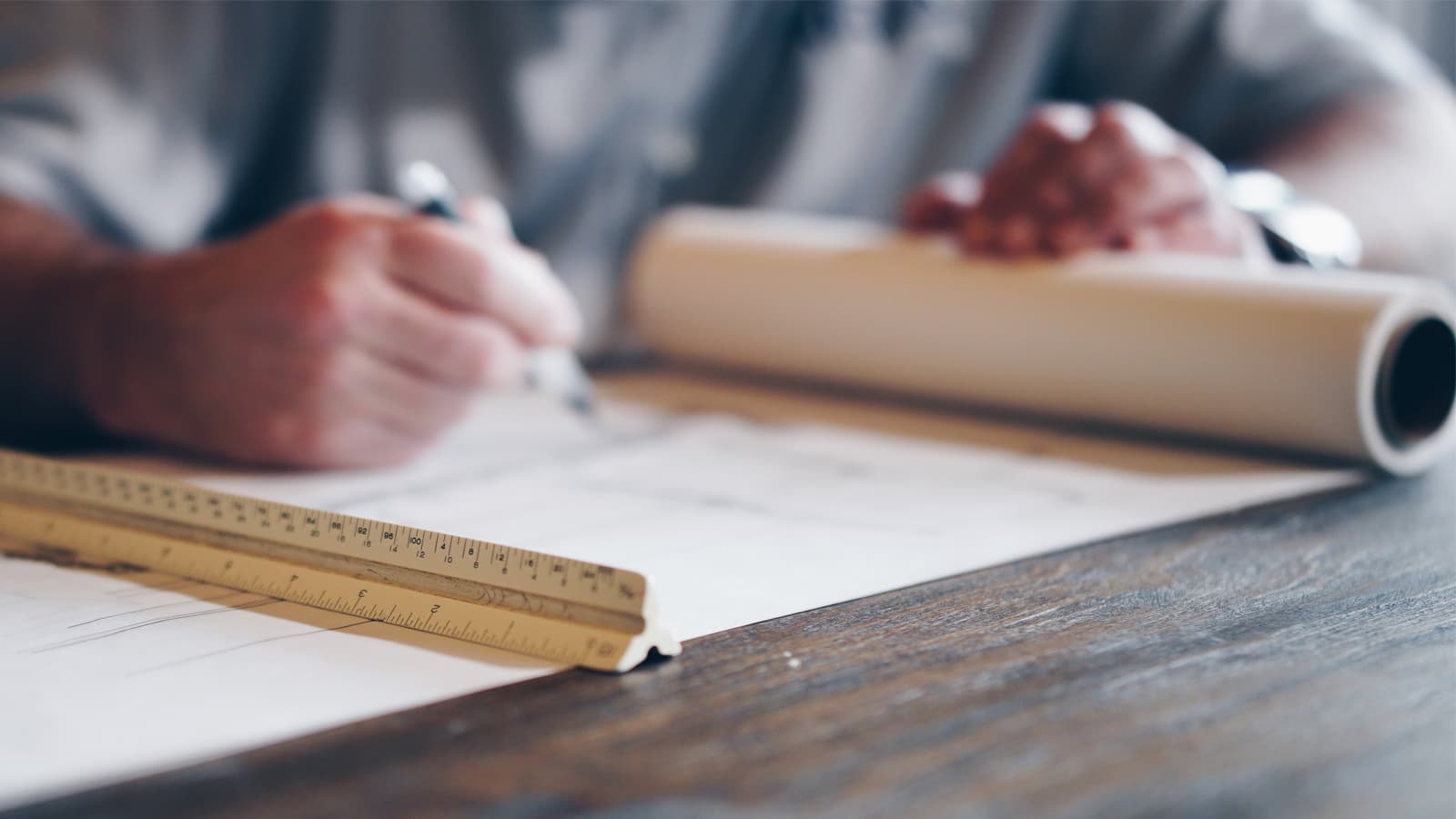 Person writing on a rolled out big piece of paper