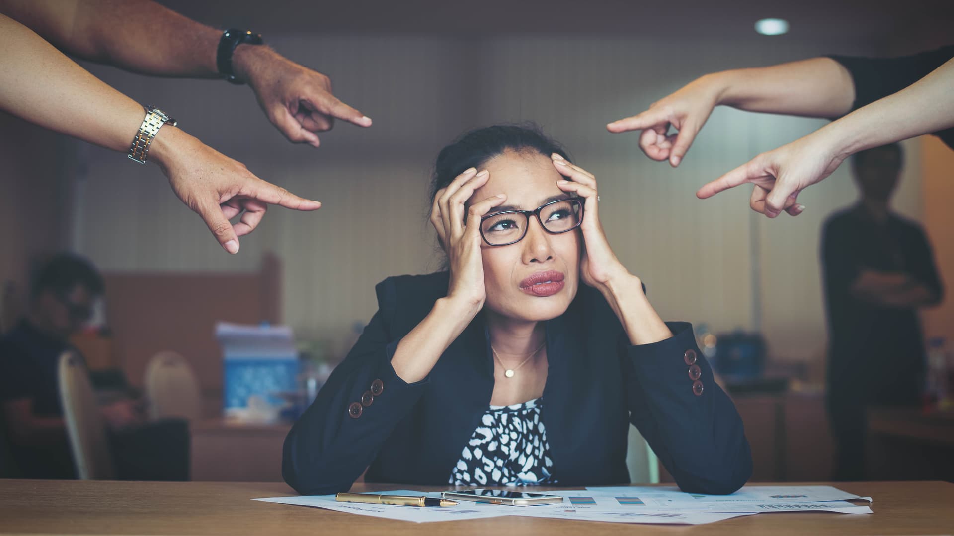 fingers pointing at a distressed woman