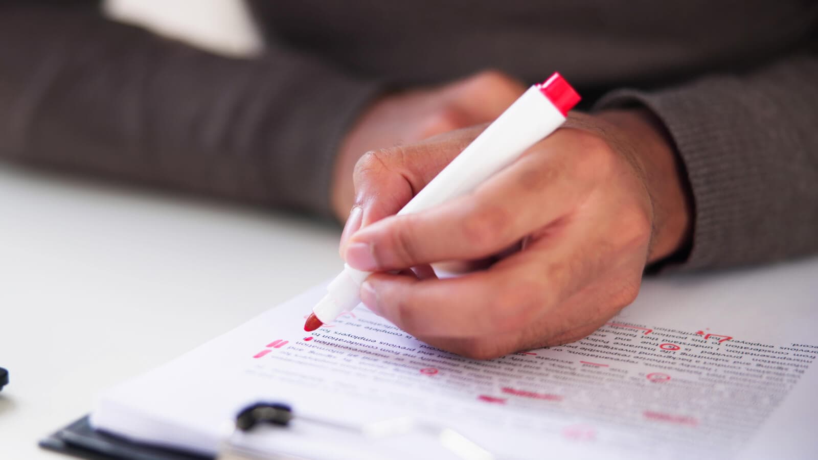 Orange pen marking up typed document