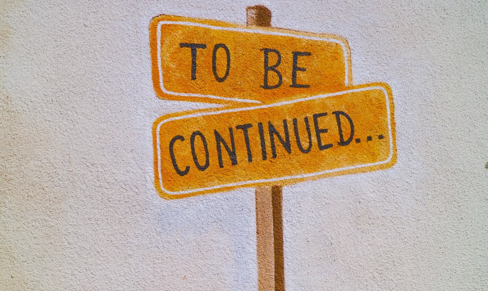 Two intersecting signs that read 'To Be Continued'