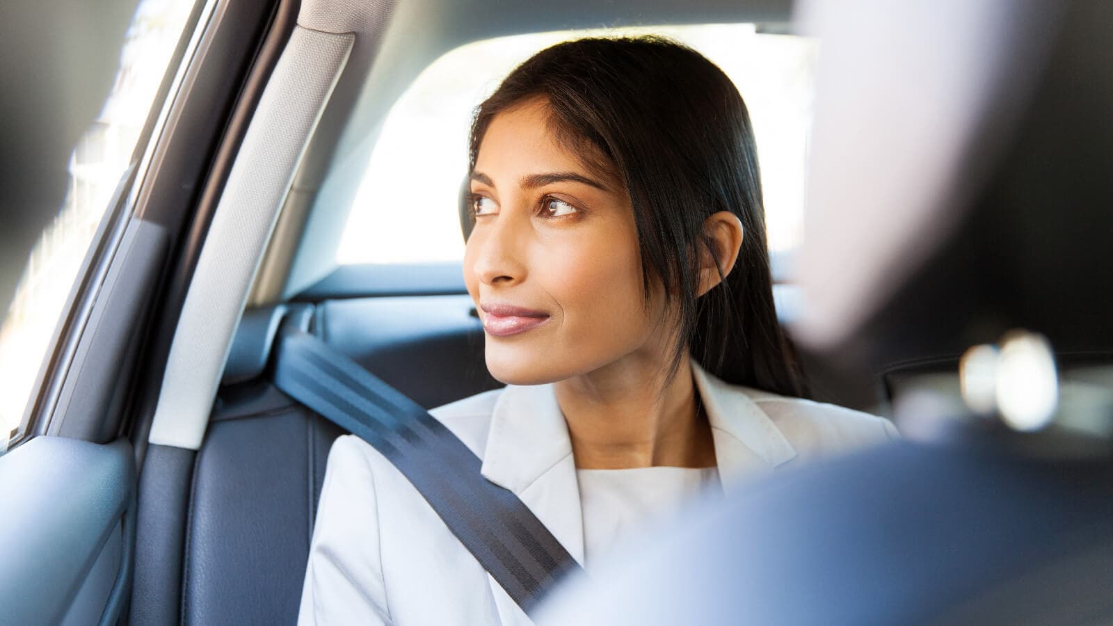 Woman looking out car window