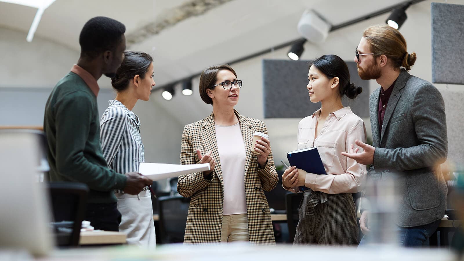 people standing together in a discussion huddle