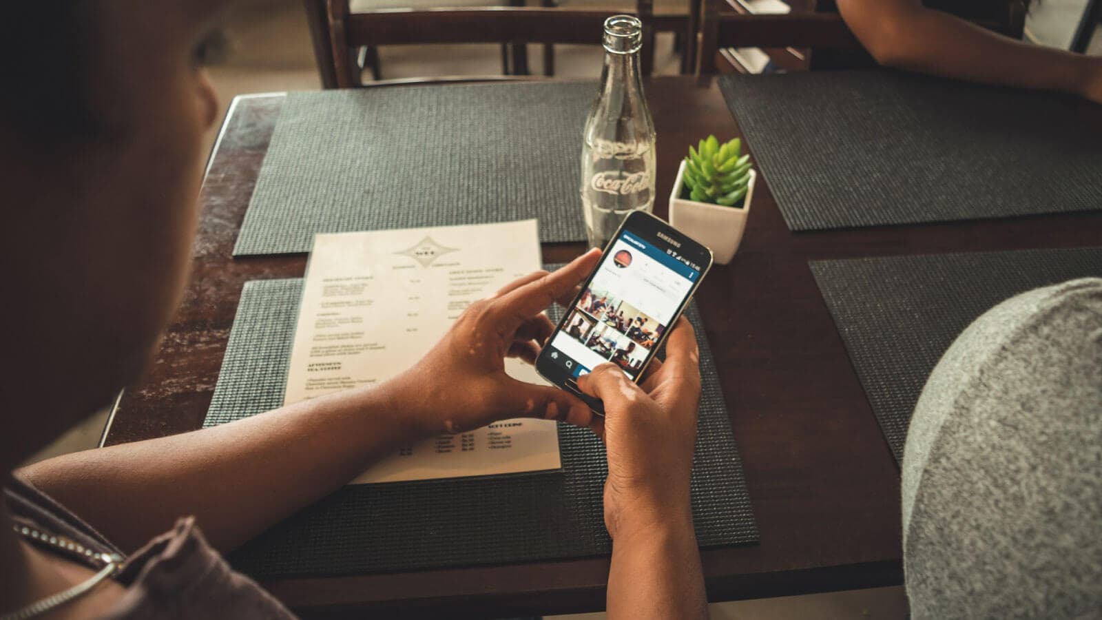 Hands typing on a phone