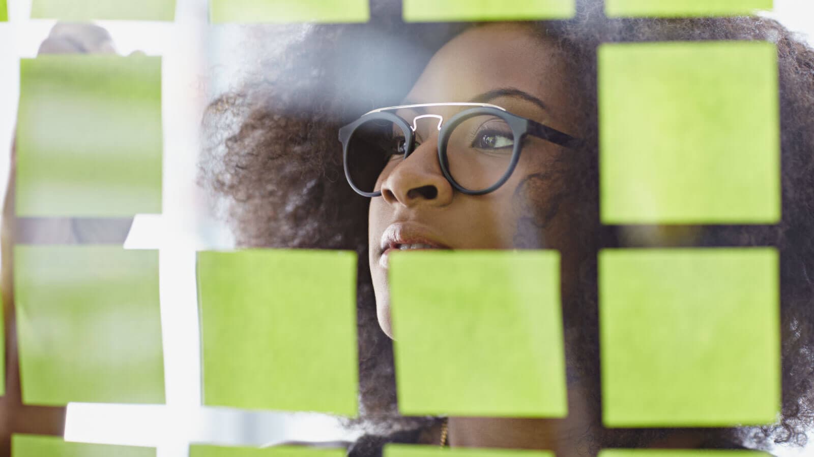 Woman writing on sticky notes