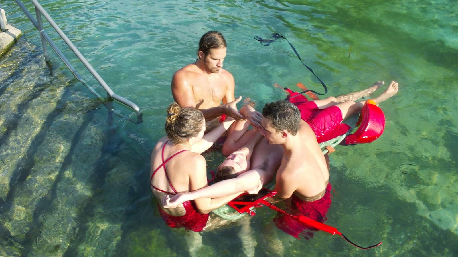 Lifeguards helping in a pool