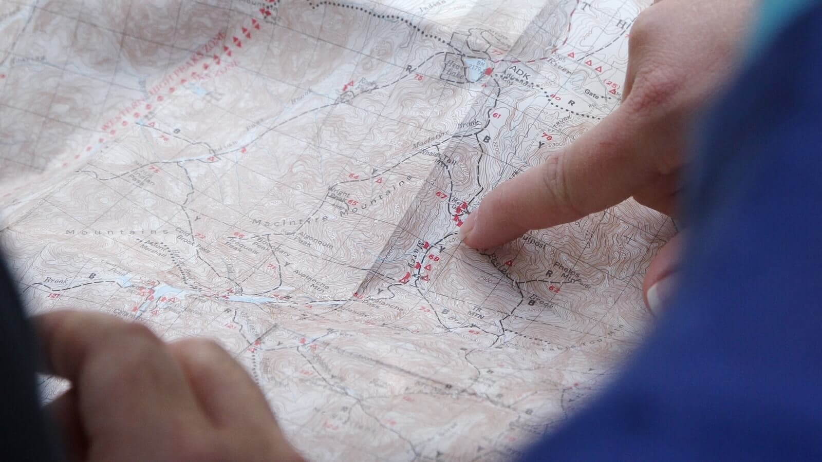 finger pointing at a map