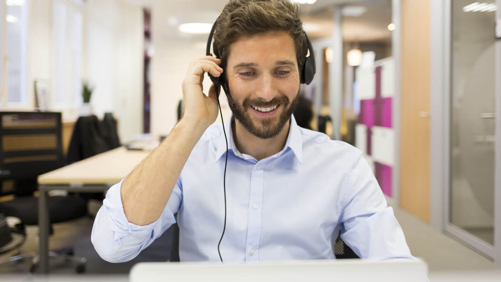 Man in office with headphones