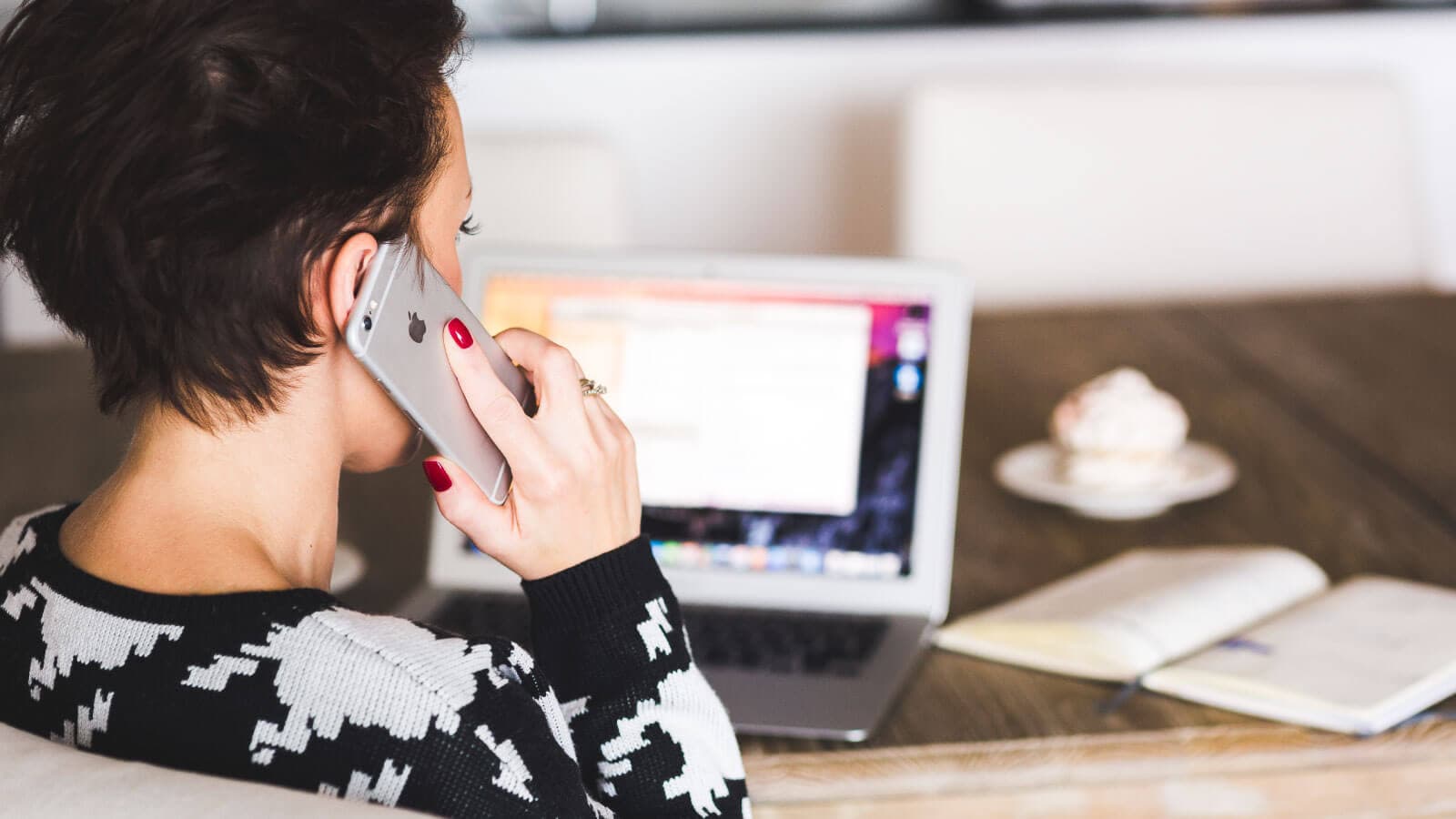 Girl at desk talking on cell phone