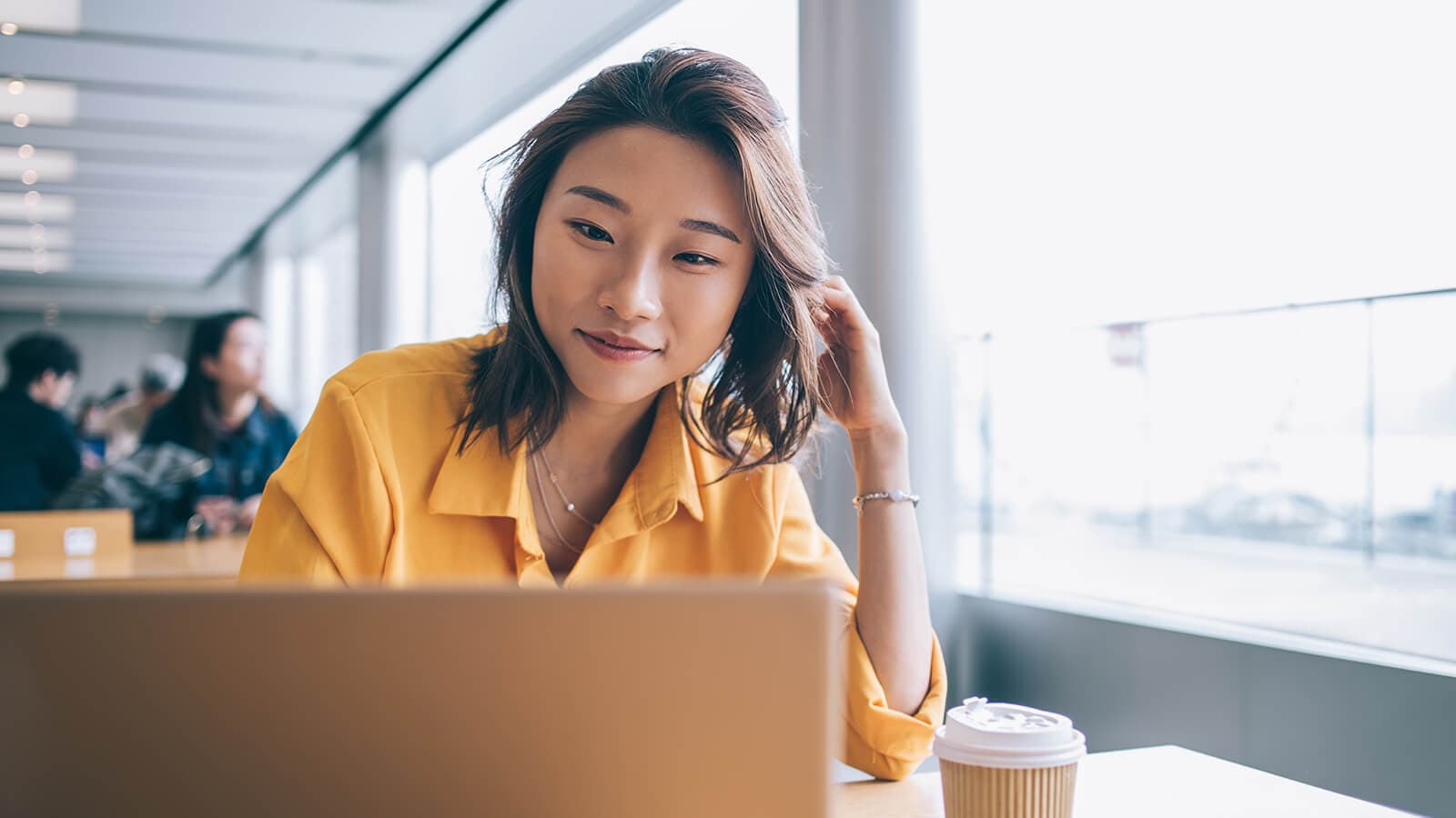 woman smiling on her laptop