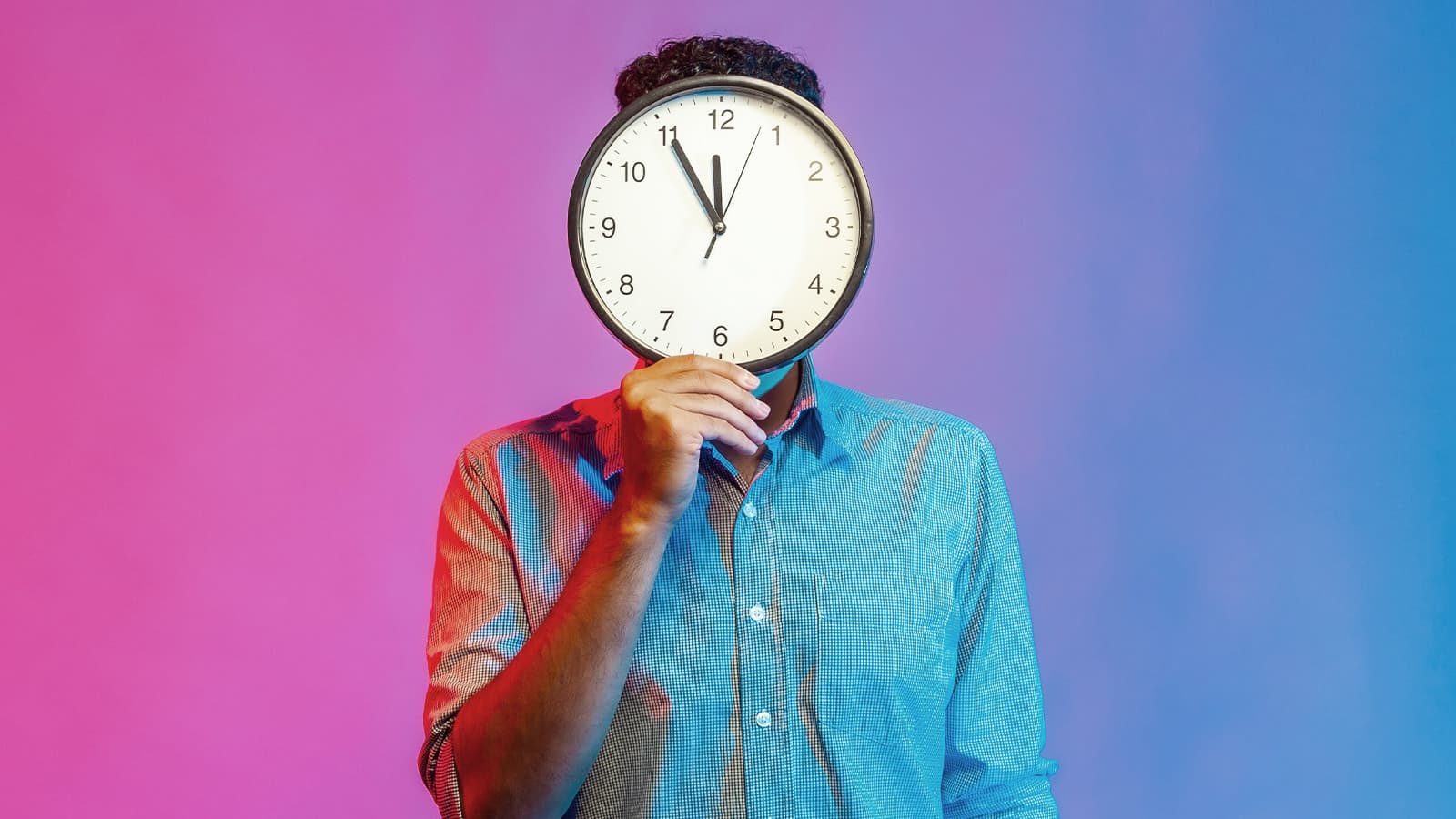 Man with clock in front of face