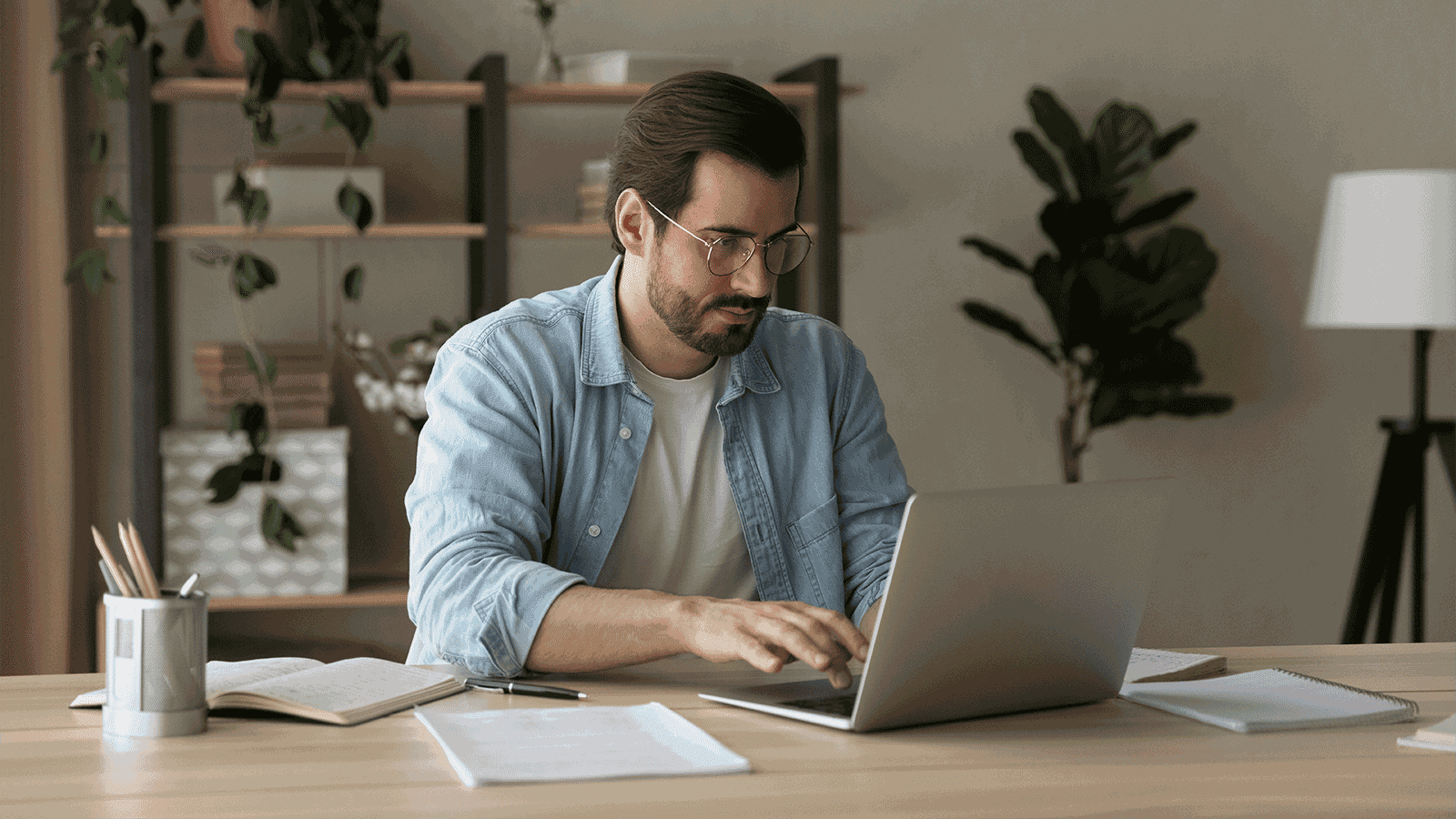 Man typing cover letter on laptop
