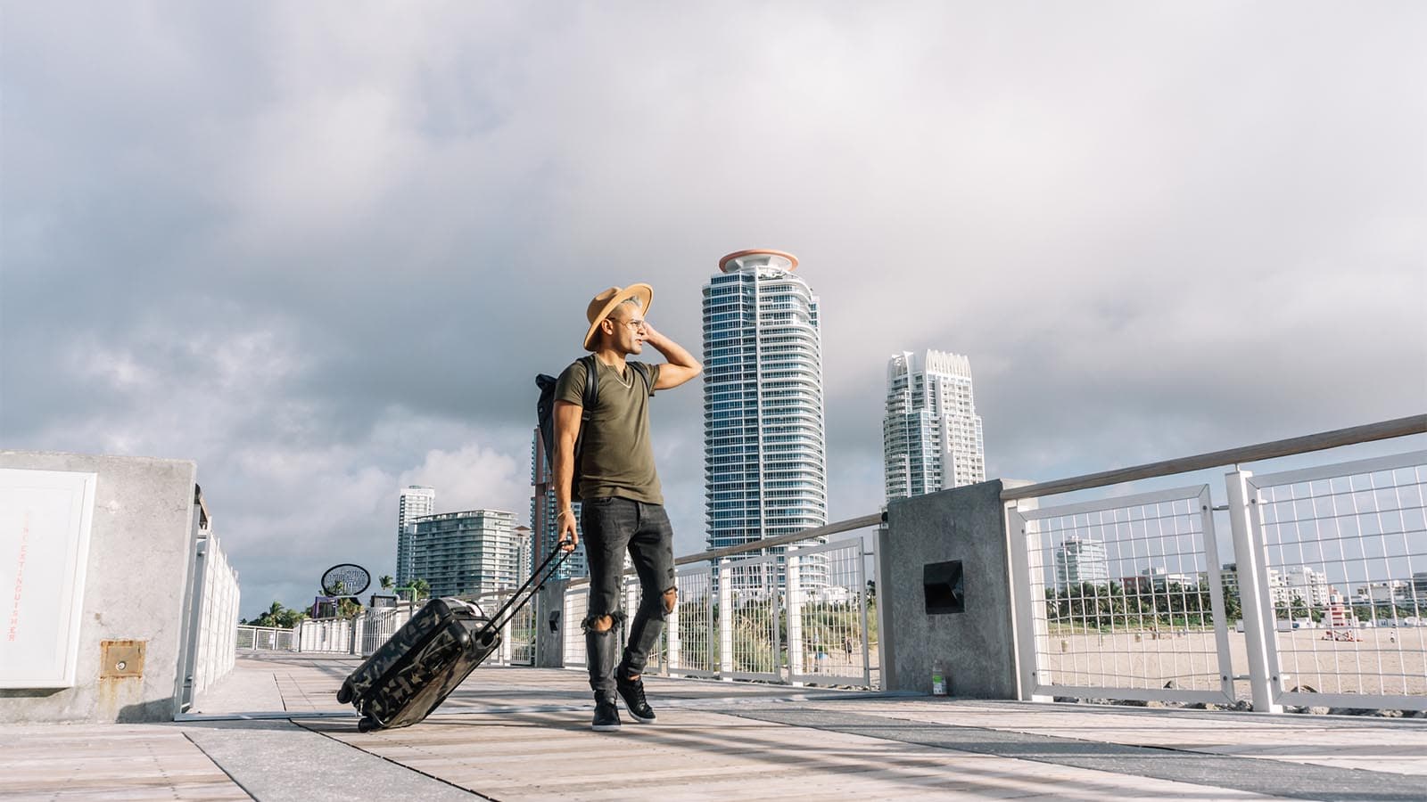 Man pulling a suitcase through the city