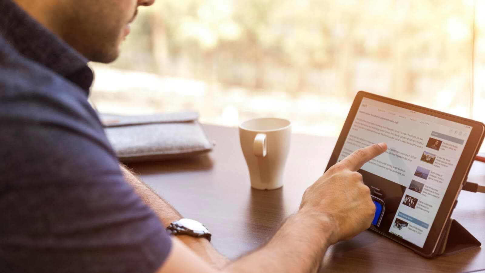 Man scrolling on ipad