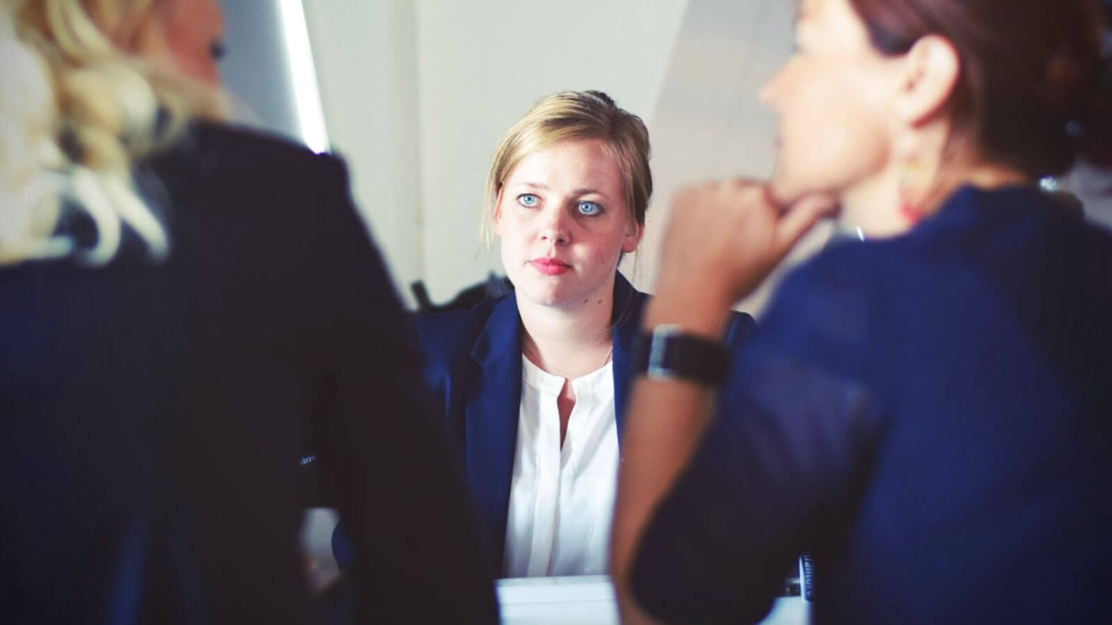 two people facing a third for an interview
