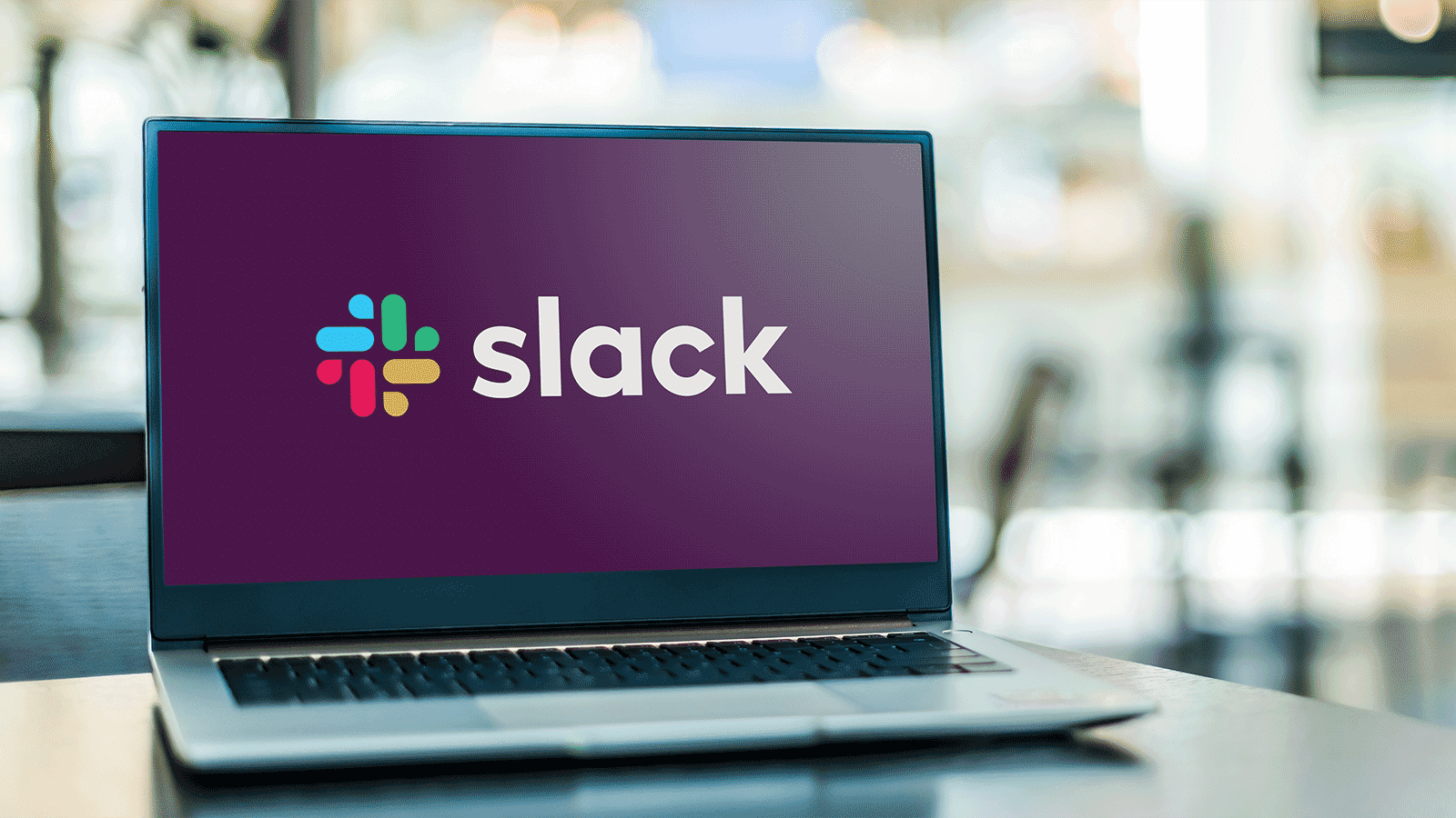 laptop screen showing slack messaging logo