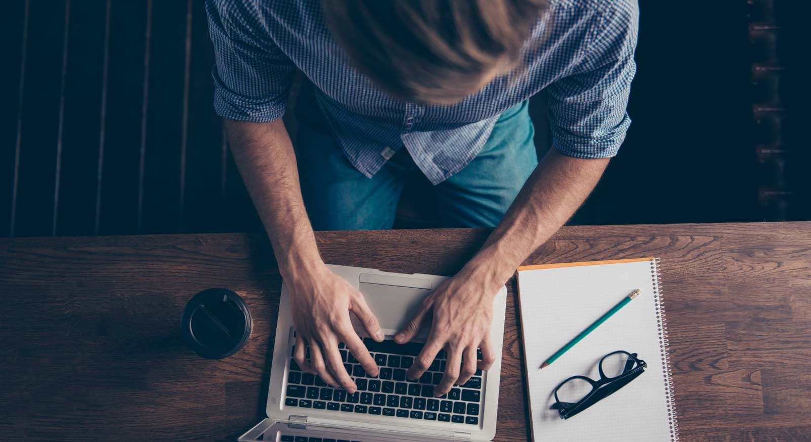 man typing at his computer