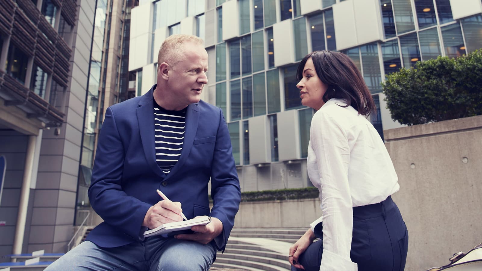 Man and woman chatting outside office