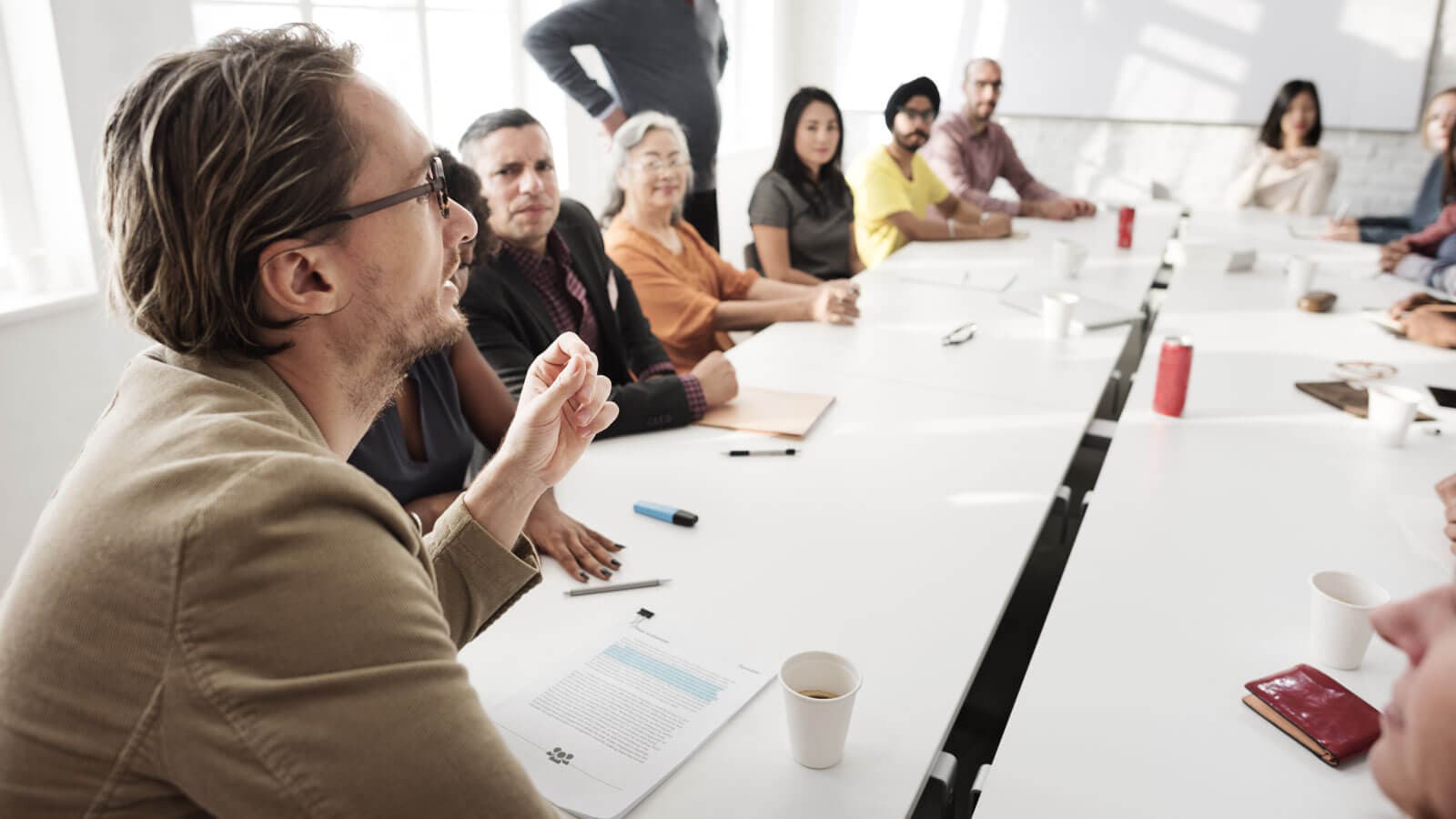 Man talking to coworkers