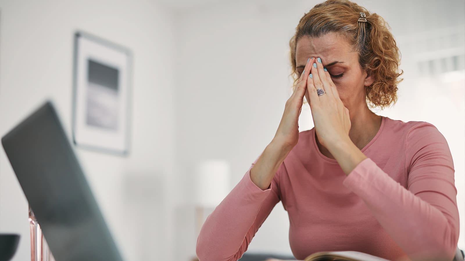 Stressed woman working remotely and burnt out