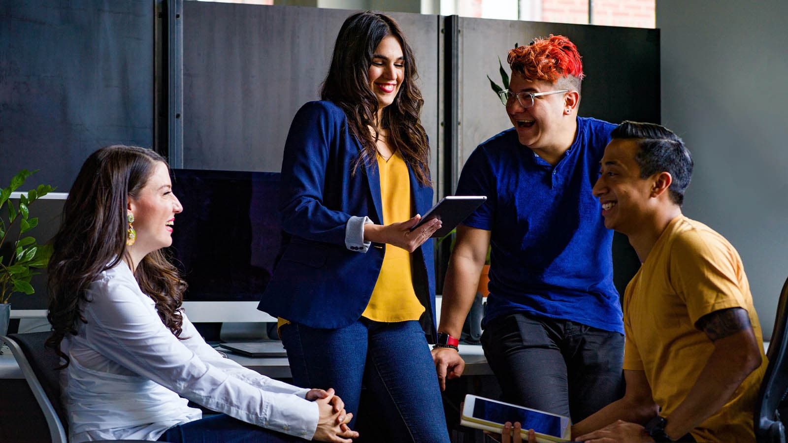 Four young business people laughing