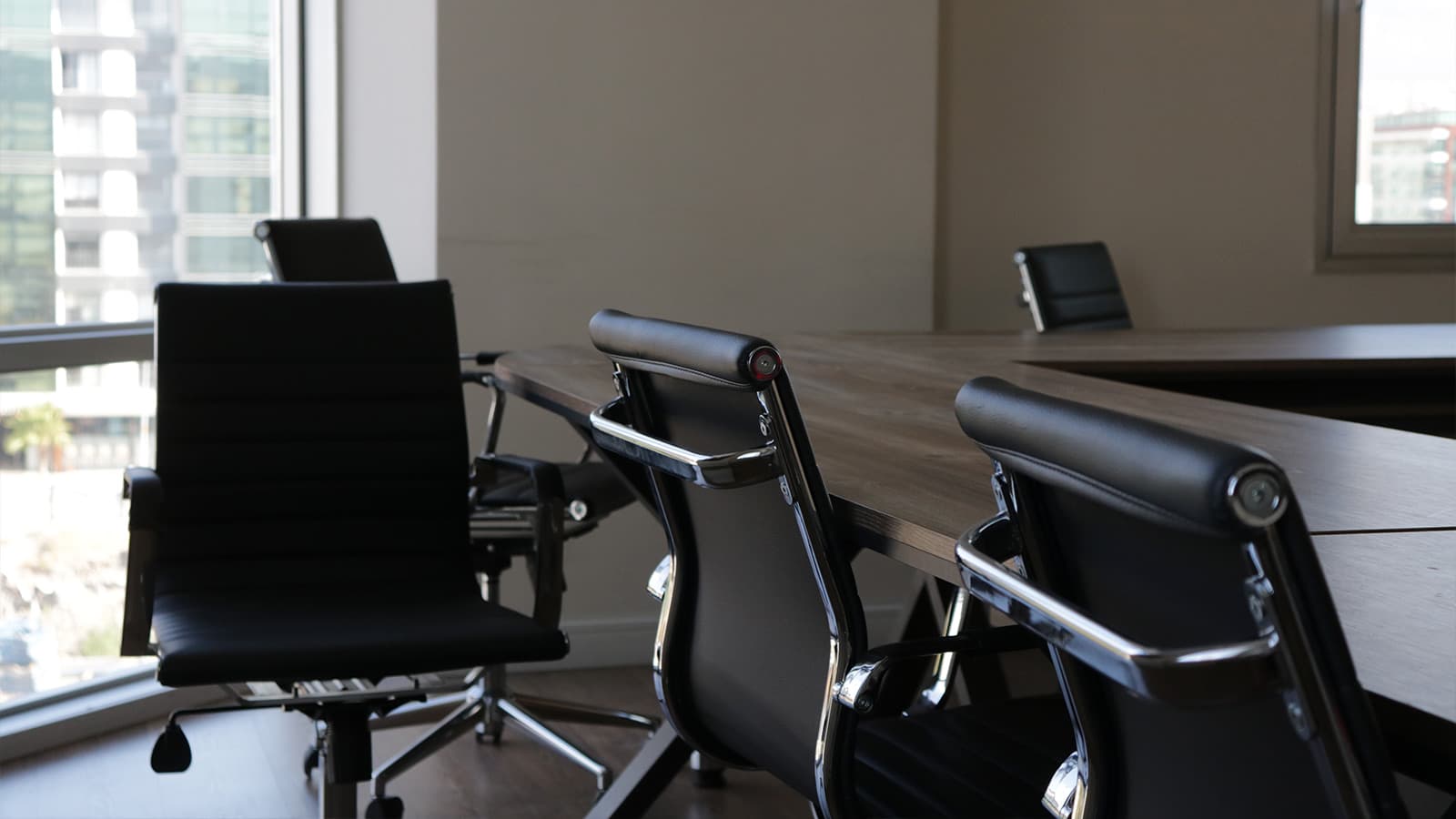 Empty chairs at a conference table