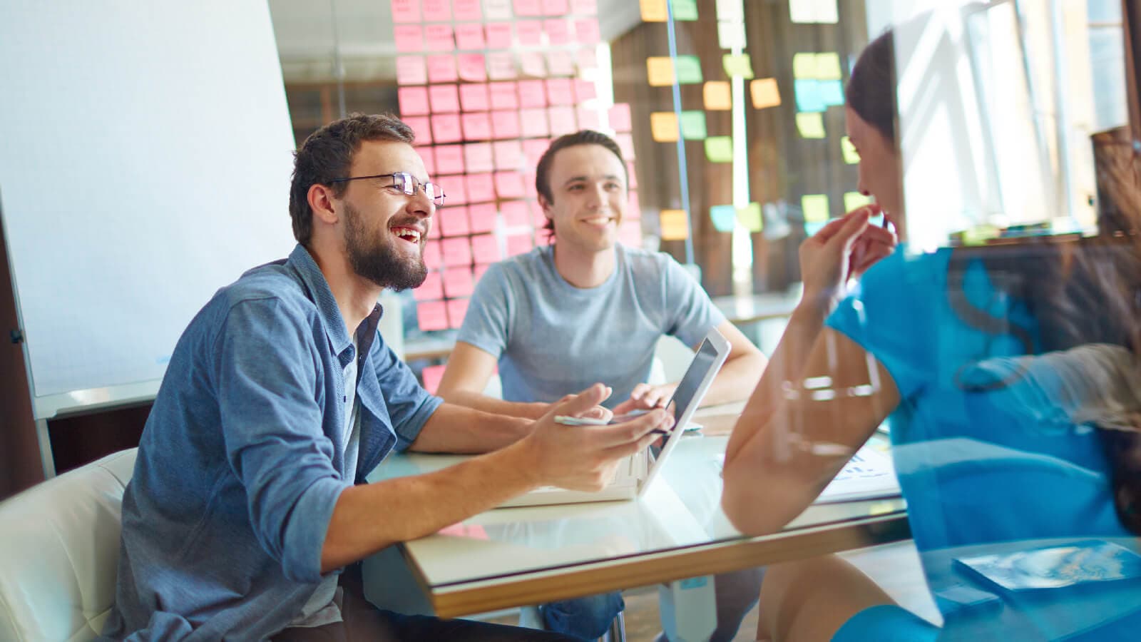 Co-workers talking around a table