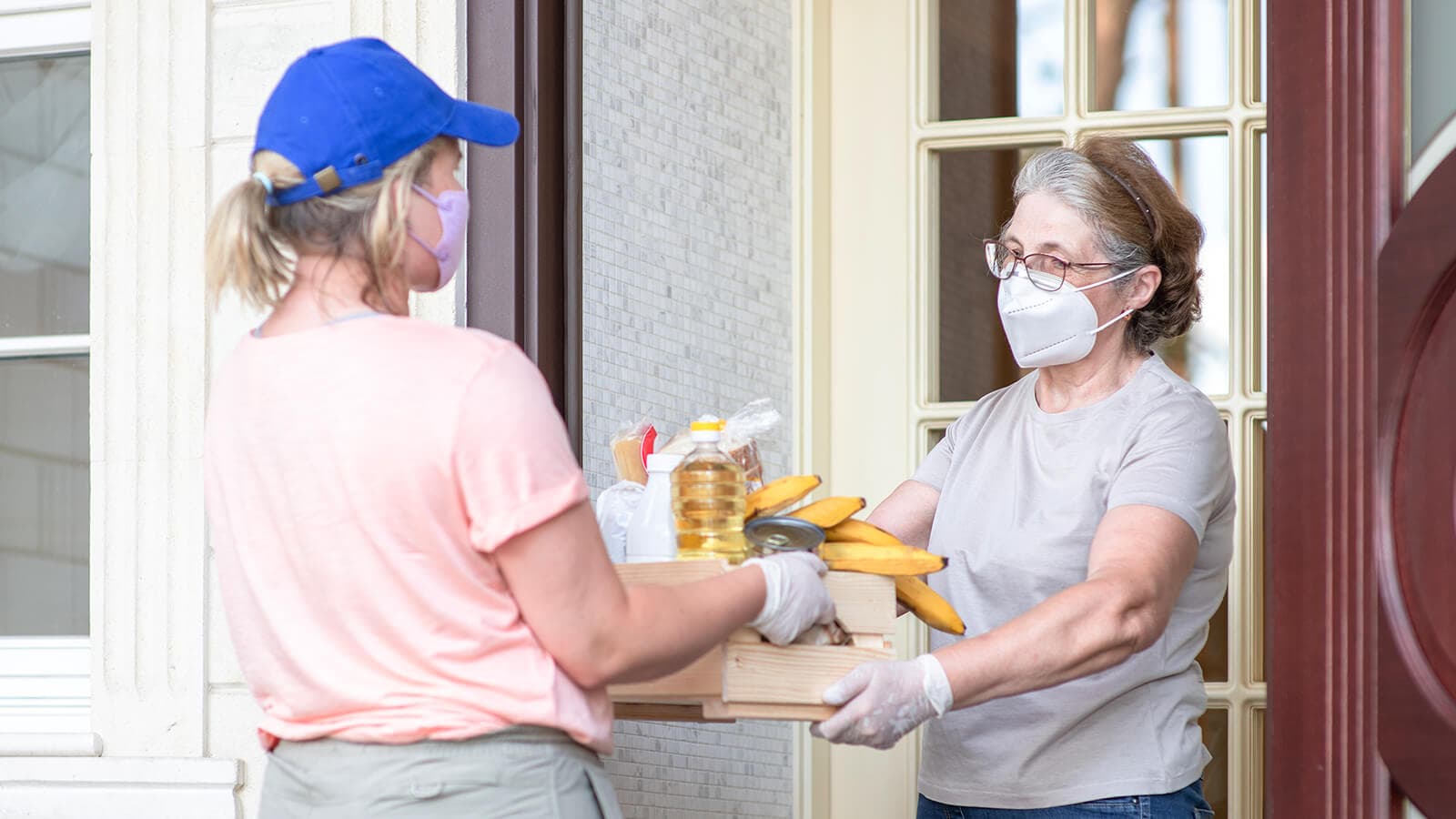 someone delivering food to masked woman