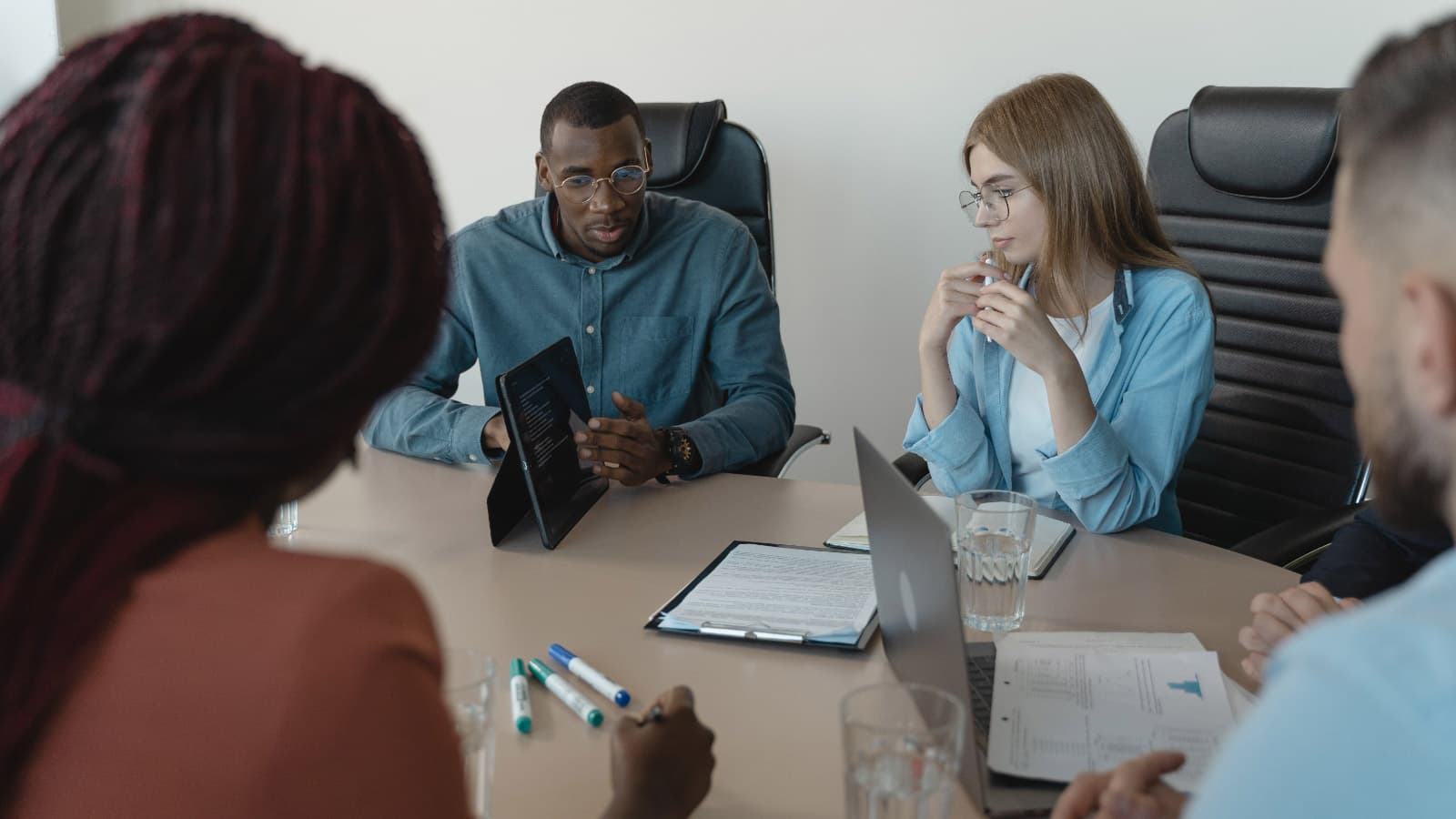 People sitting round meeting room table