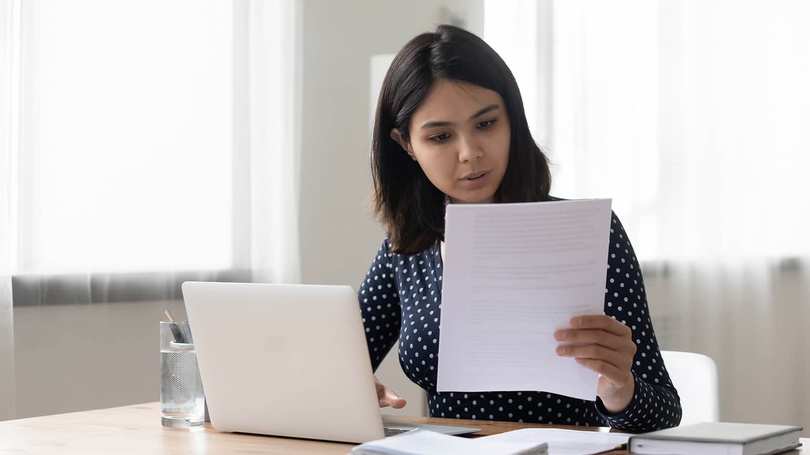 Woman looking at sheet of paper